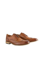 Pair of brown leather shoes on a light gray background