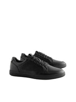 Black sneakers on a light gray background