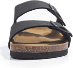 A black double-strap sandal with a cork midsole and a tan footbed, shown from a side angle on a white background.