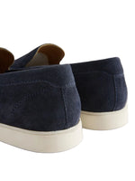 Navy blue suede shoes with white soles on a light gray background