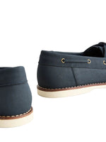 Pair of navy blue shoes with brown accents on a light gray background