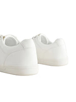 White sneakers on a light gray background