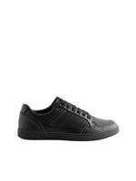 Black sneaker on a light gray background