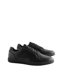 Black sneakers on a light gray background