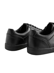 Pair of black sneakers on a light gray background