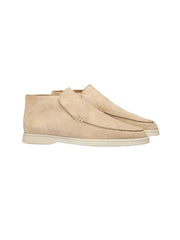 Pair of beige suede shoes on a white background