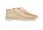 Pair of beige suede shoes on a white background