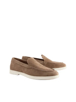 Pair of brown loafers on a light gray background