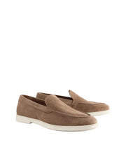 Pair of brown loafers on a light gray background