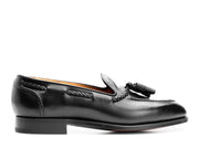 Handmade black leather tassel loafers for men with polished finish and almond toe.