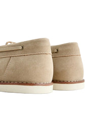 Pair of beige canvas shoes on a light gray background
