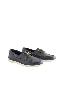 Pair of navy blue leather shoes with white soles on a light gray background
