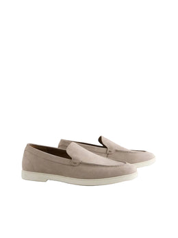 Pair of beige loafers on a light gray background