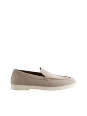 Beige loafer shoe on a light gray background