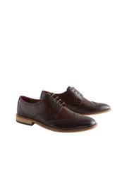 Pair of brown leather dress shoes on a light gray background