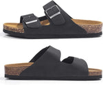 A pair of black double-strap slide sandals with silver-tone buckles and a natural cork footbed, shown from the side on a white background.