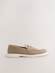 A single taupe suede penny loafer with a white sole, shown in profile against a light beige background.